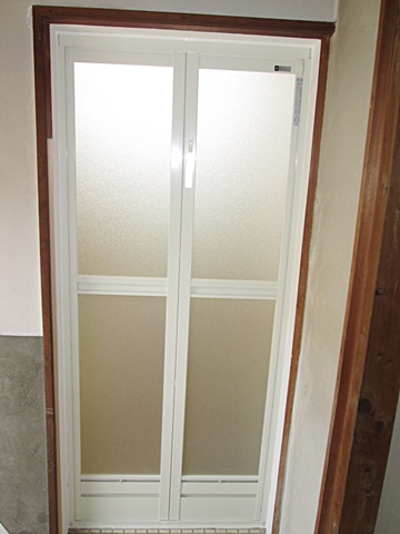 浴室のドアを取り替えました。既設の枠の中にカバー工法でアルミ製折れ戸をはめ込みました。
